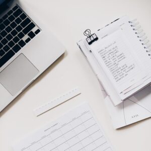 silver laptop computer near notebook